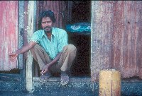 Father sitting in doorway - A Kind of Living - slide 67